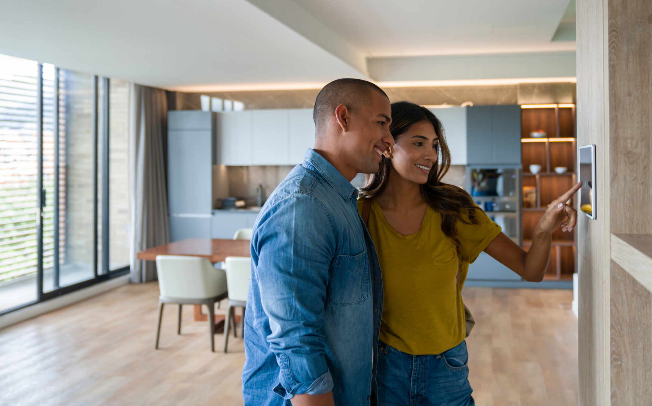 Couple Turning on Thermostat